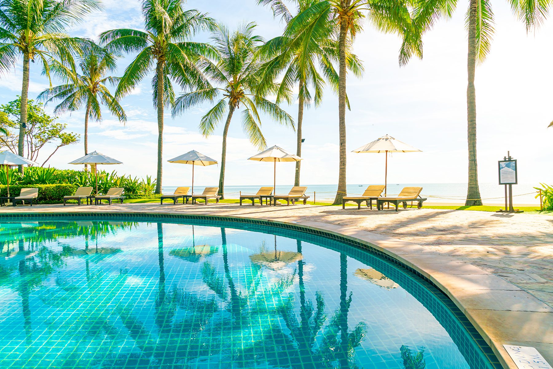 beautiful-umbrella-and-chair-around-swimming-pool-in-hotel-and-r