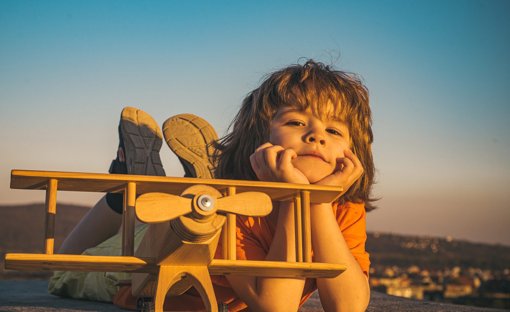 child-pilot-with-toy-airplane-dreams-of-traveling-in-summer-in-nature-kids-dreams-child-plays-with-a-toy-plane-and-dreams-of-becoming-a-pilot-summer-holidays-with-children